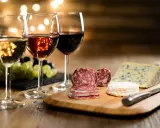 Trois verres de vin, blanc, rosé et rouge, accompagnent un plateau de fromages et charcuteries. La question est : quel vin avec le fromage ?