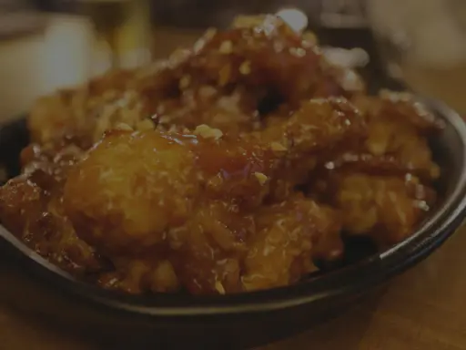 Délicieuse cuisse de poulet au four, nappée d'une sauce sucrée et parsemée de cacahuètes concassées. Un vrai régal !