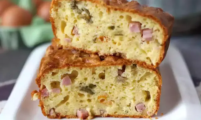 Tranche de cake jambon olive, moelleux et doré, garni de dés de jambon et d'olives vertes. Parfait pour un apéritif gourmand.